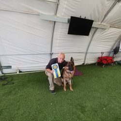 A man and his dog are posing for the camera.