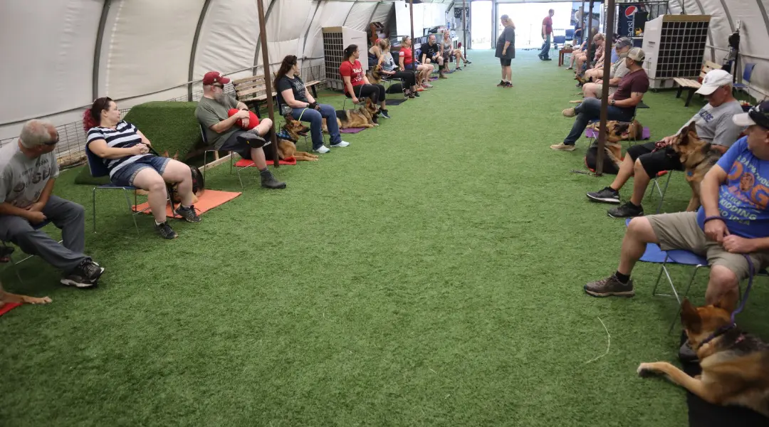 A group of people sitting on the grass.