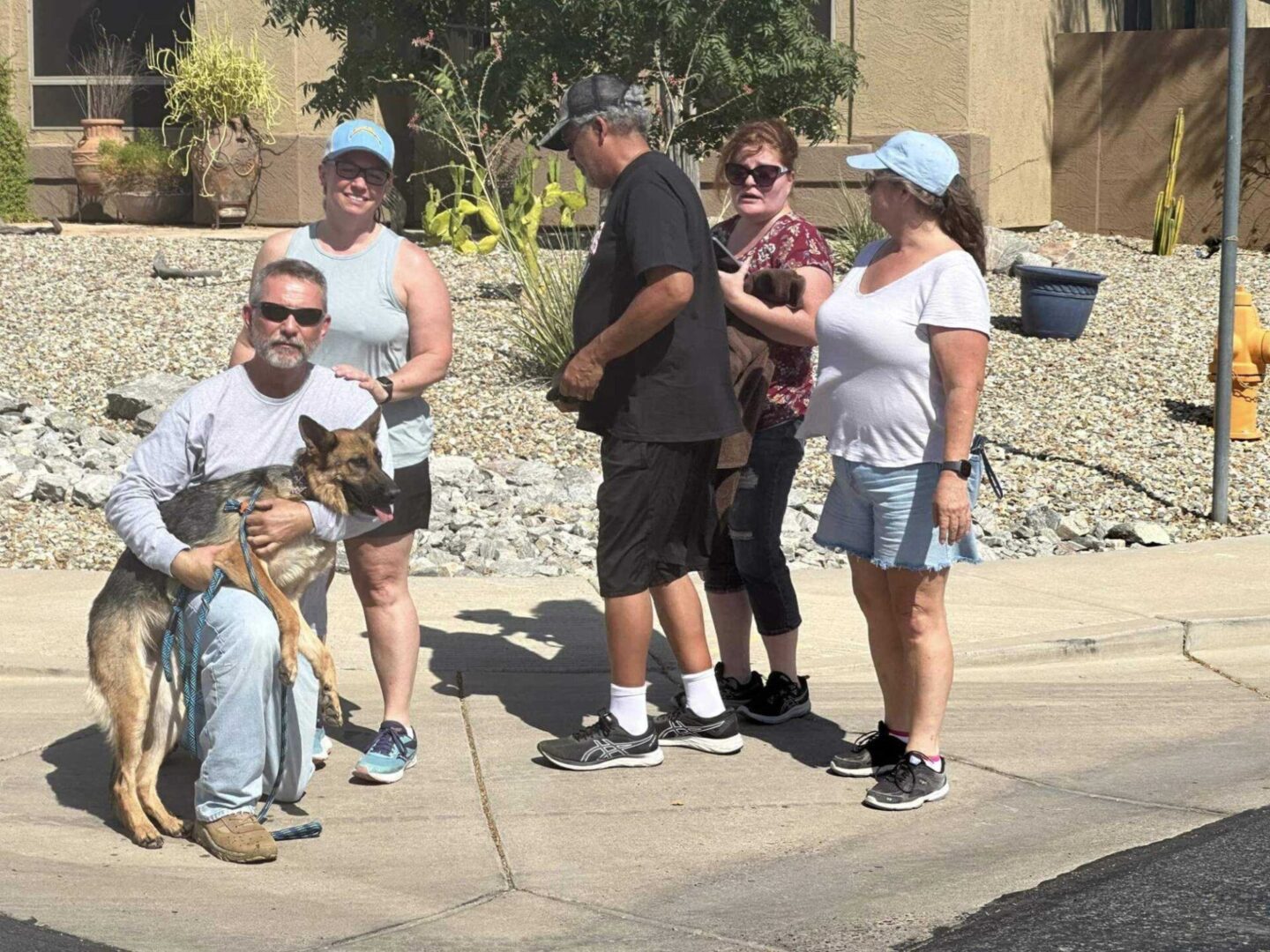 A group of people standing on the side walk