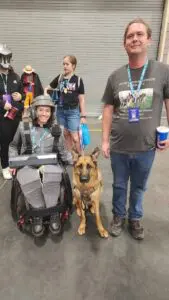 A woman in a wheelchair with her dog.
