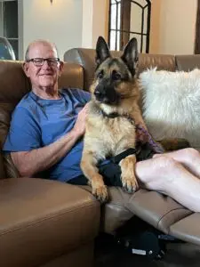 A man and his dog sitting on the couch